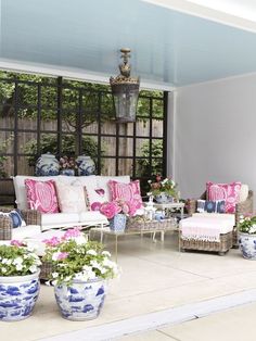 a living room filled with lots of furniture and flowers