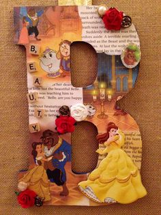 the letter b is decorated with princesses and beauty from beauty and the beast characters