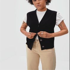 The Ultimate Transitional Layer. The Cotton Merino Sweater Vest Features A Deep V Neckline A Clean Button Front A Classic Sleeveless Design And An Easy Relaxed Fit. Plus It's Made Of A Premium Blend Of Organic Cotton And Rws-Certified Merino Wool Which Means It's Light Breathable And Perfect For In-Between Seasons. Button It Up And Wear It On Its Own Or Layer It Over A Tee For A Casual I-Just-Threw-This-On Look. The Wool In This Sweater Is Certified By The Responsible Wool Standard Which Ensures Casual Black Sweater Vest For Work, Fall Workwear Sweater Vest With Buttons, Black Cardigan With Buttons For Everyday, Black Buttoned Cardigan For Everyday, Classic Black Sweater Vest For Spring, Black Sweater Vest For Spring Workwear, Spring Black Sweater Vest For Work, Classic Sweater Vest With Button Closure For Work, Classic Black Sweater Vest For Fall