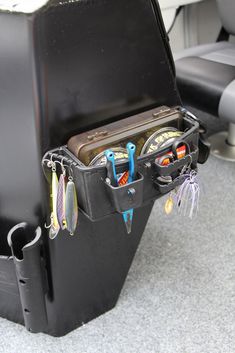 an open suitcase sitting on top of a carpeted floor next to a black chair