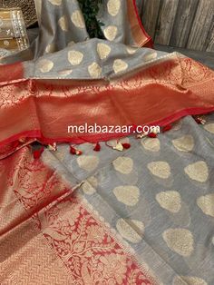 Gorgeous silk linen gray Banarsi saree with zari butas, contrast gorgeous red palla and border. Matching blouse fabric included. Fall attached. Note: The color of the products may slightly vary according to the lighting conditions and the color calibration of the viewing LED devices. If you would like more clarity before your purchase, please drop us a message. Gray Traditional Wear With Pallu, Traditional Gray Wear With Pallu, Gray Traditional Wear For Diwali, Traditional Gray Dupatta With Traditional Drape, Traditional Gray Dupatta, Gray Saree With Pallu For Festivals, Gray Chanderi Traditional Wear For Festive Occasions, Traditional Gray Festive Dupatta, Festive Gray Traditional Wear With Pallu