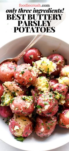 a white bowl filled with red potatoes covered in parsley