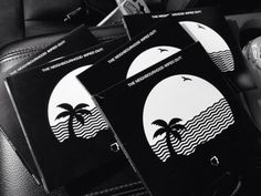 four black and white stickers with palm trees on them