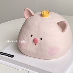 a cake shaped like a pig with a crown on top