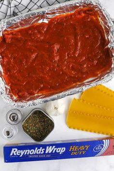 the ingredients to make homemade ravioli bread are shown in tin foil, cheese and seasoning