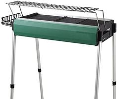 a green barbecue grill on top of a metal stand