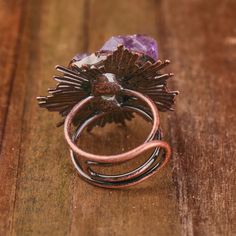 Immerse yourself in the allure of our Vintage Look Bronze Plated Adjustable Ring adorned with Natural Amethyst Crystals. Each ring is a unique masterpiece, with crystal sizes ranging from 21-25x14-16mm, creating a captivating vintage look. With a length of 32x39mm and a weight of 20g, this ring is a perfect blend of sophistication and style. Key Features: Vintage Look Design: The bronze-plated ring exudes a timeless aesthetic, reminiscent of vintage elegance. Natural Amethyst Crystals: Adorn you Adjustable Mystical Crystal Ring, Mystical Adjustable Birthstone Rings, Handmade Adjustable Mystical Crystal Ring, Adjustable Purple Crystal Ring For Healing, Adjustable Amethyst Crystal Ring With Natural Stones, Adjustable Spiritual Purple Ring, Mystical Amethyst Ring As A Gift, Mystical Amethyst Rings For Gift, Adjustable Bohemian Amethyst Ring For Gifts