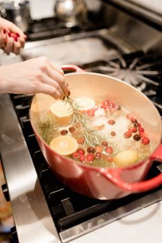 a person cooking food in a pan on the stove