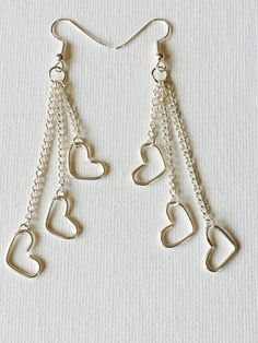 Triple silver plated hearts charms on silver plated chains dangling earrings. The silver plated wire, chains, and earring hooks are tarnish resistant and nickel and lead free. Made in Hawaii. Ships from Hawaii. These darling earrings are a great gift for a loved one! Wire Charms, Wire Hearts, Diy Wire Jewelry Rings, Wire Jewelry Earrings, Wire Jewelry Patterns, Wire Jewelry Rings, Wire Jewellery, Wire Jewelry Designs, Bracelet Diy