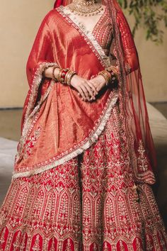 Editor's Note Vermillion Silk Lehenga Choli With Soft Tulle Dupatta Gold Zari, Mokaish, Resham , Crystal And Dabka Embellishments. Color: Red Fabric: Silk Care: Dry Clean Only About the Designe... Red Gota Work Choli For Reception, Red Floor-length Lehenga With Gota Work, Red Art Silk Lehenga With Gota Work, Red Cutdana Traditional Wear For Reception, Traditional Sets With Gota Work For Reception, Traditional Gota Work Sets For Reception, Red Kundan Sets For Transitional Season, Red Semi-stitched Lehenga With Gota Work, Red Sharara For Transitional Wedding Season