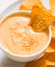 a white plate topped with chips and dip