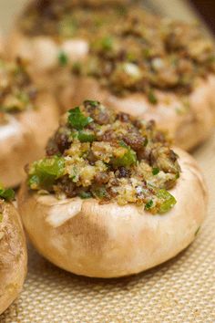 baked stuffed mushrooms with various toppings on a tableclothed surface, ready to be eaten