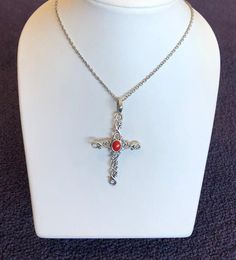 This cross displays a beautiful piece of Red Coral in the middle of a wavy cross. The cross is about 2.5" and 1.5" in width. The chain is 18"Please let us know if you have any questions! Red Spiritual Cross Pendant Jewelry, Red Crucifix Cross Necklace Gift, Red Crucifix Cross Necklace For Gift, Red Cross Pendant Necklace Gift, Red Cross Pendant Necklace For Gift, Spiritual Red Cross Pendant Necklace, Dragon Ring, Vintage Diamond Rings, Sterling Silver Cross