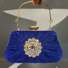 LOW STOCK WARNING Stand out from the crowd with the Anya Pleated Craft Rhinestone Handbag. It features a pleated design and a sophisticated embellishment on the front giving it an overall elegant look. This handbag has ample space for your essentials and is the perfect choice for any woman who loves luxury. Now available in blue, gold, black, and silver. Rhinestone Handbags, Cotton Handbag, Floral Heels, Gold Handbags, Shirt Dress Casual, Designer Handbag, Mini Shirt Dress, Boot Bag, Black And Silver