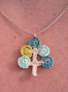 a crocheted tree pendant on a woman's chest