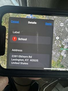 someone is holding up their cell phone to show the location on the map and directions