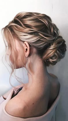 a woman with blonde hair in a low bun