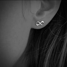 a woman's ear with an infinite symbol on it