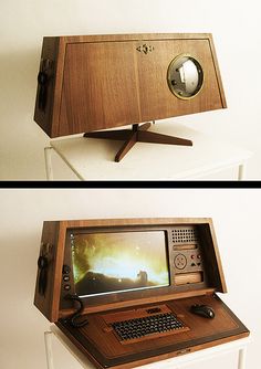 an old computer sitting on top of a white table next to a wooden desk with a monitor and keyboard