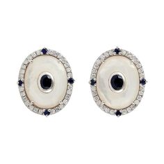 Handcrafted from 14-karat gold, these stud earrings are set with .40 carats of diamonds, 4.55 carats Mother of Pearl and .65 carats sapphire. FOLLOW MEGHNA JEWELS storefront to view the latest collection & exclusive pieces. Meghna Jewels is proudly rated as a Top Seller on 1stDibs with 5 star customer reviews. All items manufactured by us are handmade and can be customized or redesigned. Composition Size-17X14 MM Total Weight-6.68 Gold Weight(Gms)-5.56 Diamond Wt(Cts)-0.4 Mother of Pearl Wt(Cts) Gold Stud Earrings, Mother Pearl, Gold Stud, Sapphire Diamond, Gold Earrings Studs, Gold Studs, Jewelry Earrings Studs, Gemstone Earrings, Mother Of Pearl