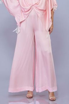 Light pink blended satin kaftan with draped detailing. Comes with a jumpsuit. - Aza Fashions Draped Silk Sets For Summer, Elegant Silk Wide Leg Palazzo Set, Elegant Pink Pants For Eid, Chic Wide Leg Palazzo Set, Sleeveless Pink Palazzo Set For Summer, Sleeveless Pink Summer Palazzo Set, Pink Silk Evening Pants, Silk Jumpsuits And Rompers For Summer, Summer Party Palazzo Set