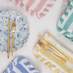 napkins, forks and knives are laid out on a table with blue and white stripes