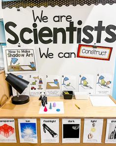 a desk with posters and pictures on it that say we are scientist's, we can construct