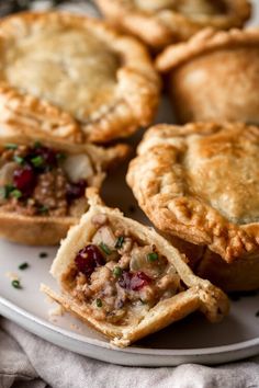 several small pies on a plate with one cut in half and the other partially eaten