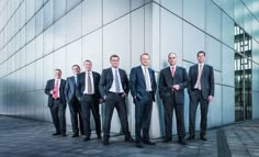 a group of men in suits standing next to each other