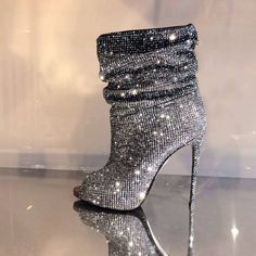 Step out in style with our Silver Strass Hotfix Slouch Boots! Featuring a peep toe design, stiletto heel, and dazzling embellishments, these booties are a must-have for fashion-forward individuals. Color: Silver Heel Type: Stiletto heel Heel Height: 4.5" / 115 mm approx Product measurements were taken using size 8. Please note that measurements may vary by size. Toe: Peep toe All-over rhinestone embellishment Handcrafted US sizing. Fits true to size. Glamorous Party Boots With Bling, Glamorous Open Toe Fitted Boots, Fitted Glamorous Open Toe Boots, Glamorous Fitted Open Toe Boots, Glamorous Open Toe Party Boots, Glamorous Open Toe Formal Boots, Silver Fitted Heels With Bling, Fitted Silver Heels With Bling, Silver Bling Heels With Fitted Design