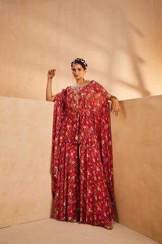 Featuring a floral-printed kaftan and sharara. The kaftan’s neckline is embroidered by hand using a mirror, sequences, and beadwork. The tie-up is accentuated with mirrors and the kaftan hem is accentuated with antique gold coins.From Aneesh Agarwaal's Seher collection.DELIVERY TIMEPlease allow 8-12 weeks for your outfit to arrive.FABRIC DETAILSChinonProfessional cleaning only. Bohemian Dresses With Cape Sleeves For Festive Occasions, Festive Bohemian Dress With Cape Sleeves, Red Georgette Sharara With Printed Motifs, Bollywood Style Dresses With Floral Embroidery And Cape Sleeves, Bollywood Dresses With Floral Embroidery And Cape Sleeves, Bohemian Sharara With Printed Motifs In Georgette, Red Georgette Kaftan For Festive Occasions, Festive Red Kaftan With Printed Motifs, Bohemian Georgette Sharara With Printed Motifs