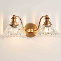 This bathroom light fixture features a vintage matte antique finish and a crystal glass shade, combining timeless elegance with modern appeal. Rosdorf Park Finish: Brass | Rosdorf Park Nalley 2 - Light Dimmable Vanity Light yellowGlass in Brass | 7.87" H X 17.72" W X 9.06" D | Wayfair Bathroom Vanity Lights Over Mirror, Vintage Bathroom Light Fixtures, Vanity Lights Over Mirror, Bathroom Doorway, Vintage Bathroom Lighting, Vintage Bathroom Vanity, Retro Vanity, Bathroom Vanity Lights, Gold Wall Lights