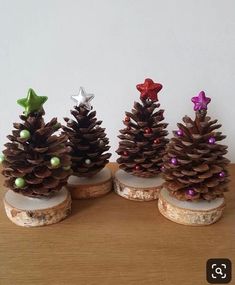 three small pine cones with decorations on them