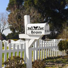 a white picket fence with a sign that says beam