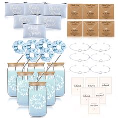 a set of four blue mason jars filled with wedding favors and place cards for the bride