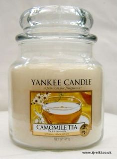 yankee candle in a glass jar with an image of a cup of tea on it