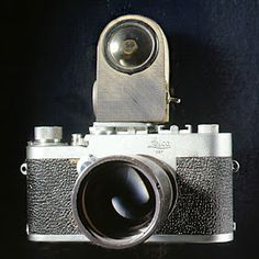 an old camera with a lens attached to it