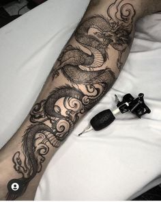 a man with a dragon tattoo on his arm