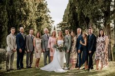 a group of people standing next to each other on top of a grass covered field