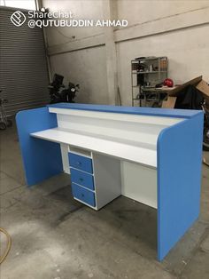 a blue and white desk in a garage