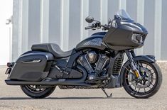 a black motorcycle parked in front of a building