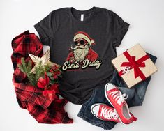 Get into the holiday spirit with our Santa's Favorite Christmas T-shirt! Made from soft, high-quality cotton, this shirt features a playful design that's perfect for any Christmas celebration. Whether you're attending a holiday party, trimming the tree, or just spreading seasonal joy, this comfortable and stylish tee is a must-have for your festive wardrobe. Available in a range of sizes and colors, it's the perfect gift for yourself and your loved ones. Celebrate the magic of Christmas! .: Made Casual Christmas T-shirt As Gift, Casual T-shirt As Holiday Gift, Christmas Cotton T-shirt Gift, Holiday Gift Cotton T-shirt, Cotton T-shirt As Holiday Gift, Santa Shirts, Funny Christmas Shirts, Christmas Tshirts, Playful Design