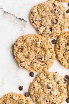 cookies and chocolate chips laid out on a marble surface