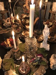 a table topped with candles and dishes filled with food