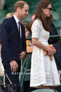 the duke and princess of cambridge are standing next to each other at a tennis match