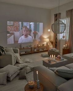 a living room filled with furniture and a flat screen tv mounted to the side of a wall