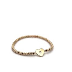 Discover elegance and charm with our LOVE HEART Gold Filled Beads Bracelet, a delightful addition to any jewelry collection. This stunning piece combines the timeless appeal of gold filled beads with a heart-shaped pendant crafted from gold plated sterling silver. Designed to be adjustable, it offers both style and comfort, making it perfect for everyday wear or special occasions. Handcrafted in our Miami workshop, each bracelet is made to order with meticulous attention to detail. We prioritize Elegant Heart-shaped Jewelry With Gold Beads, Dainty Heart Charm Bracelet With Round Beads, Dainty Jewelry With Heart Charm And Round Beads, Elegant Gold Stretch Bracelet With Heart Beads, Dainty Gold Stretch Bracelet As Gift, Elegant Beaded Heart-shaped Stretch Bracelet, Elegant Heart-shaped Beaded Bracelet, Elegant Stretch Bracelet With Heart Charm, Dainty Bracelet With Heart Charm And Round Beads