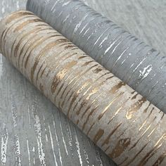 two rolls of metallic foil sitting on top of each other