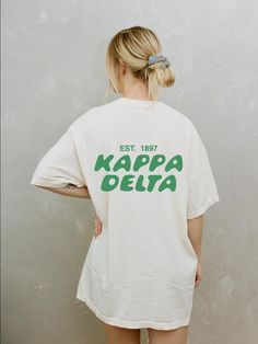 Soft, cute, and trendy, this Kappa Delta sorority t-shirt will quickly become your go-to cozy shirt! Use the drop down to specify preference between white, ivory, chambray, orchid, or blossom. LISTING IS FOR KAYDEE. Please be sure you are ordering for your correct Sorority. We print on high quality, soft, & heavyweight materials, sustainably made and printed in the US. ♥ SIZING ♥ Unisex Sizing- For a more feminine, fitted look we recommend getting your size. For a more oversized look, we recomme Kappa Delta Shirt, Oversized School Spirit T-shirt With Letter Print, White School Spirit T-shirt For Everyday, School Spirit T-shirt With Text Print For Everyday, White Short Sleeve Sorority Top, Cotton Sorority Top With Text Print, Crew Neck T-shirt With School Spirit, Cute White T-shirt For College, Cute White College T-shirt