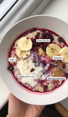 a bowl of oatmeal with bananas, blueberries and other toppings